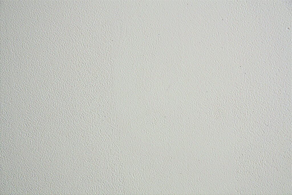 Close-up of a textured white wall, ideal for backgrounds in design projects.